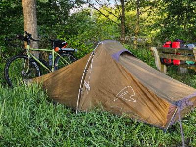 Second nights pitch. This one was literally feet away from the country lane we were riding on. In the Netherlands near Diepenheim. A makeshift roadside pitch using a picnic table bench to attach a tarp to.