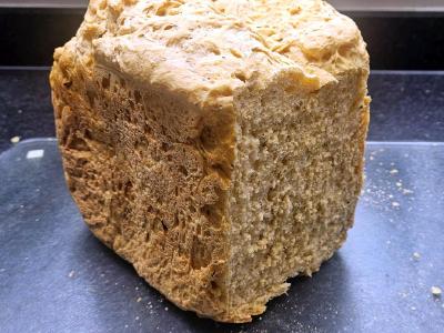 Cheddar Cheese and Sun Dried Tomato Loaf Tomato and cheese loaf with the cut end showing an open, slightly uneven crumb.