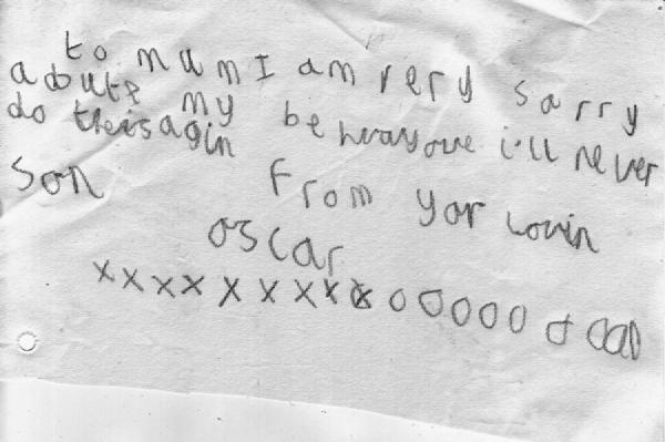 A handwritten note on lined paper with the message to Mum I am very sorry about my behaviour I&rsquo;ll never do it again from your loving son followed by multiple X marks and O marks representing kisses and hugs
